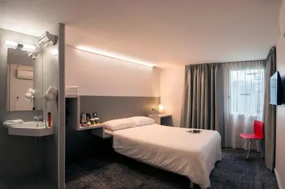 Un ou plusieurs lits dans un hébergement de l'établissement L'hôtel by JOA de Saint-Paul-Lès-Dax