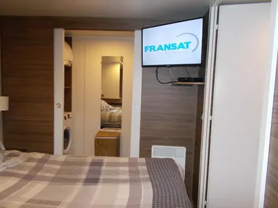 Un ou plusieurs lits dans un hébergement de l'établissement mobilhome charme funpass et wifi inclus