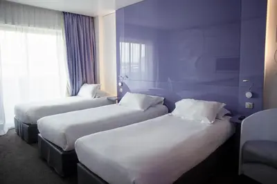 Un ou plusieurs lits dans un hébergement de l'établissement Comfort Aparthotel Bassin d'Arcachon