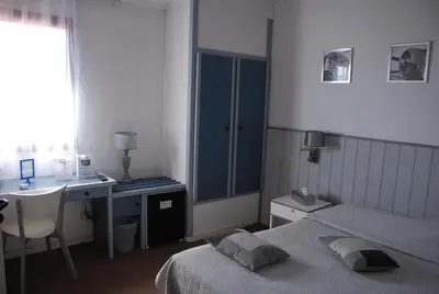 Un ou plusieurs lits dans un hébergement de l'établissement Hotel Atlantide