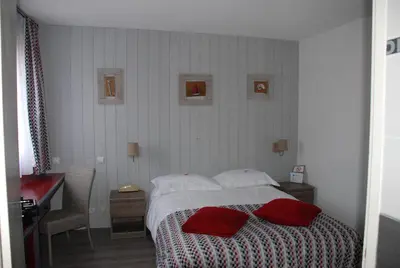 Un ou plusieurs lits dans un hébergement de l'établissement Hotel Atlantide