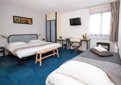Un ou plusieurs lits dans un hébergement de l'établissement Hotel Atlantide