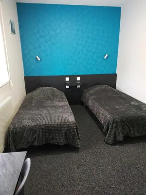 Un ou plusieurs lits dans un hébergement de l'établissement Hôtel Bar des Arènes