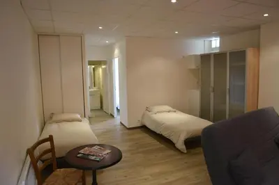 Un ou plusieurs lits dans un hébergement de l'établissement Hôtel Des Arceaux