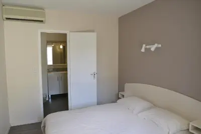 Un ou plusieurs lits dans un hébergement de l'établissement Hôtel Des Arceaux