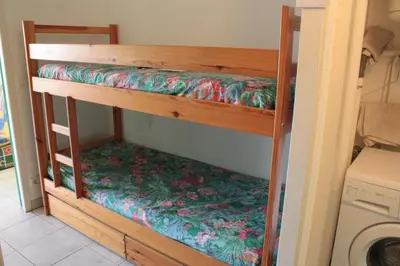 Un ou plusieurs lits dans un hébergement de l'établissement Appartement Moliets plage, avec piscine