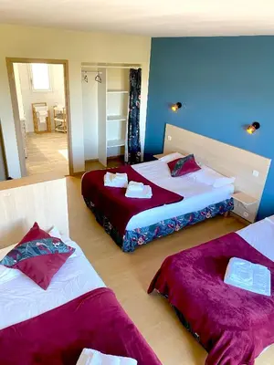 Un ou plusieurs lits dans un hébergement de l'établissement Hôtel Le Plaisance
