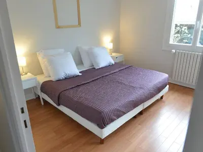 Un ou plusieurs lits dans un hébergement de l'établissement Appartement de vacances avec jardin à Tarnos