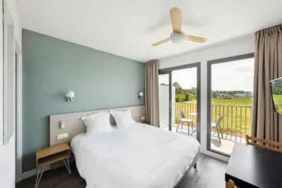 Un ou plusieurs lits dans un hébergement de l'établissement All Suites Appart Hôtel - Bassin d'Arcachon - Dune du Pilat