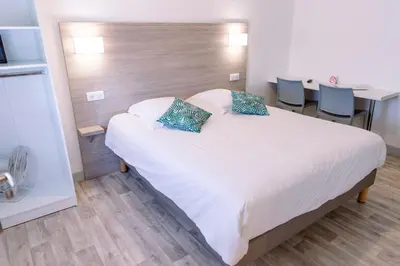 Un ou plusieurs lits dans un hébergement de l'établissement Hotel Atlantique