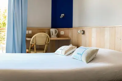 Un ou plusieurs lits dans un hébergement de l'établissement Hotel Bar Tabac Point Chaud L'Ecureuil