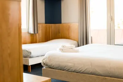 Un ou plusieurs lits dans un hébergement de l'établissement Hotel Bar Tabac Point Chaud L'Ecureuil