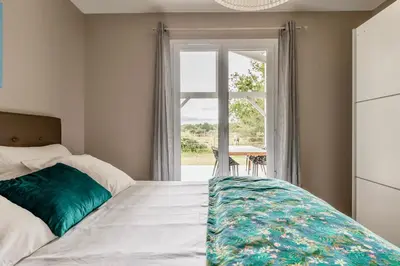 Un ou plusieurs lits dans un hébergement de l'établissement LA VILLA LANDAISE jacuzzi et piscine chauffée