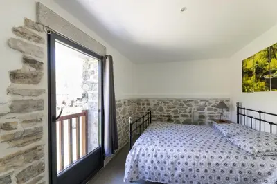Un ou plusieurs lits dans un hébergement de l'établissement Gîte Le Moulin Pocheluberry