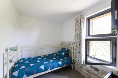 Un ou plusieurs lits dans un hébergement de l'établissement Gîte Le Moulin Pocheluberry