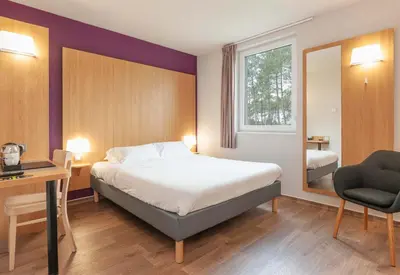 Un ou plusieurs lits dans un hébergement de l'établissement B&B HOTEL Mont-de-Marsan