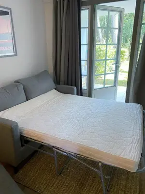 Un ou plusieurs lits dans un hébergement de l'établissement Appartement du Golf Les Bastides piscine et océan