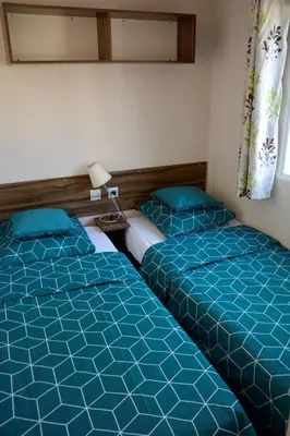 Un ou plusieurs lits dans un hébergement de l'établissement MOBILHOME 6/8 Personnes 3Ch LA RESERVE ****