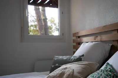 Un ou plusieurs lits dans un hébergement de l'établissement Chaleureux appartement à 500m de l’océan et 150m du Golf Moliets-Plage