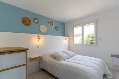 Un ou plusieurs lits dans un hébergement de l'établissement Maison Mimizan plage