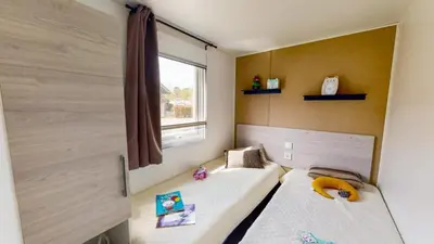 Un ou plusieurs lits dans un hébergement de l'établissement Camping Officiel Siblu La Plage