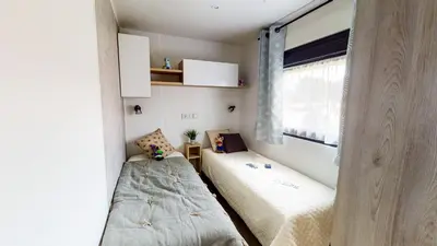 Un ou plusieurs lits dans un hébergement de l'établissement Camping Officiel Siblu Le Pipiou