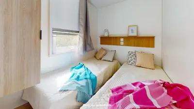 Un ou plusieurs lits dans un hébergement de l'établissement Camping Officiel Siblu Les Oyats
