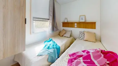 Un ou plusieurs lits dans un hébergement de l'établissement Camping Officiel Siblu Les Oyats