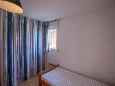 Un ou plusieurs lits dans un hébergement de l'établissement Résidence Vacancéole Sun Hols Les Villas du Lac