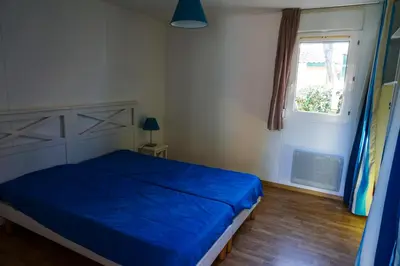 Un ou plusieurs lits dans un hébergement de l'établissement Villas du lac